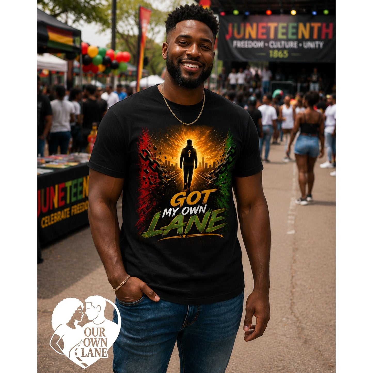 Handsome Black male model wearing a black Juneteenth t-shirt featuring the Got My Own Lane graphic with red, gold, green artwork symbolizing freedom and empowerment.