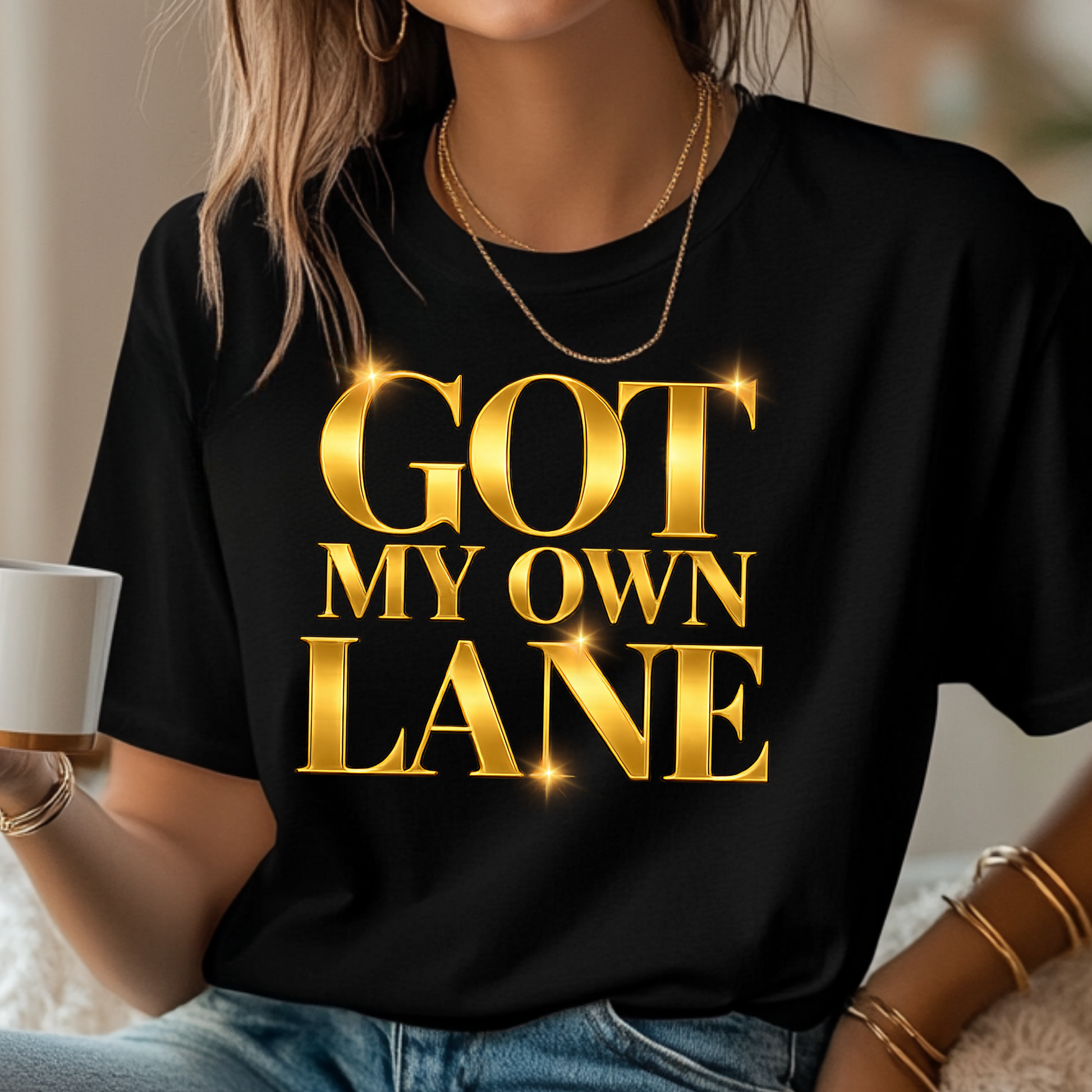 Woman wearing Got My Own Lane Signature Gold logo tee on a black t-shirt