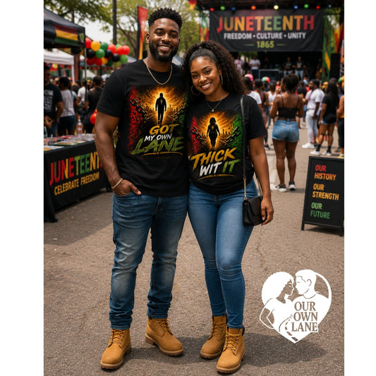 Black couple at a Juneteenth celebration wearing matching empowerment t-shirts featuring Got My Own Lane and Thick Wit It graphics in Pan African colors.