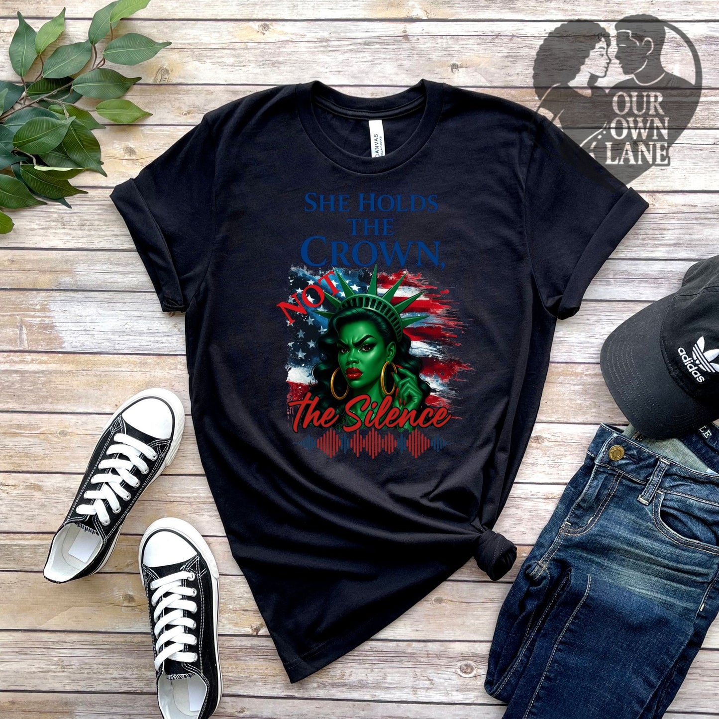 Black unisex t-shirt featuring She Holds the Crown Not the Silence empowerment graphic by Our Own Lane